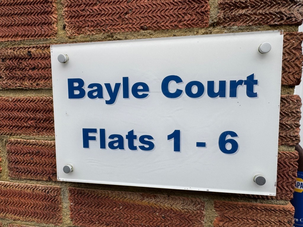 Lot: 147 - TWO-BEDROOM APARTMENT WITH SEA VIEWS - Bayle Court sign